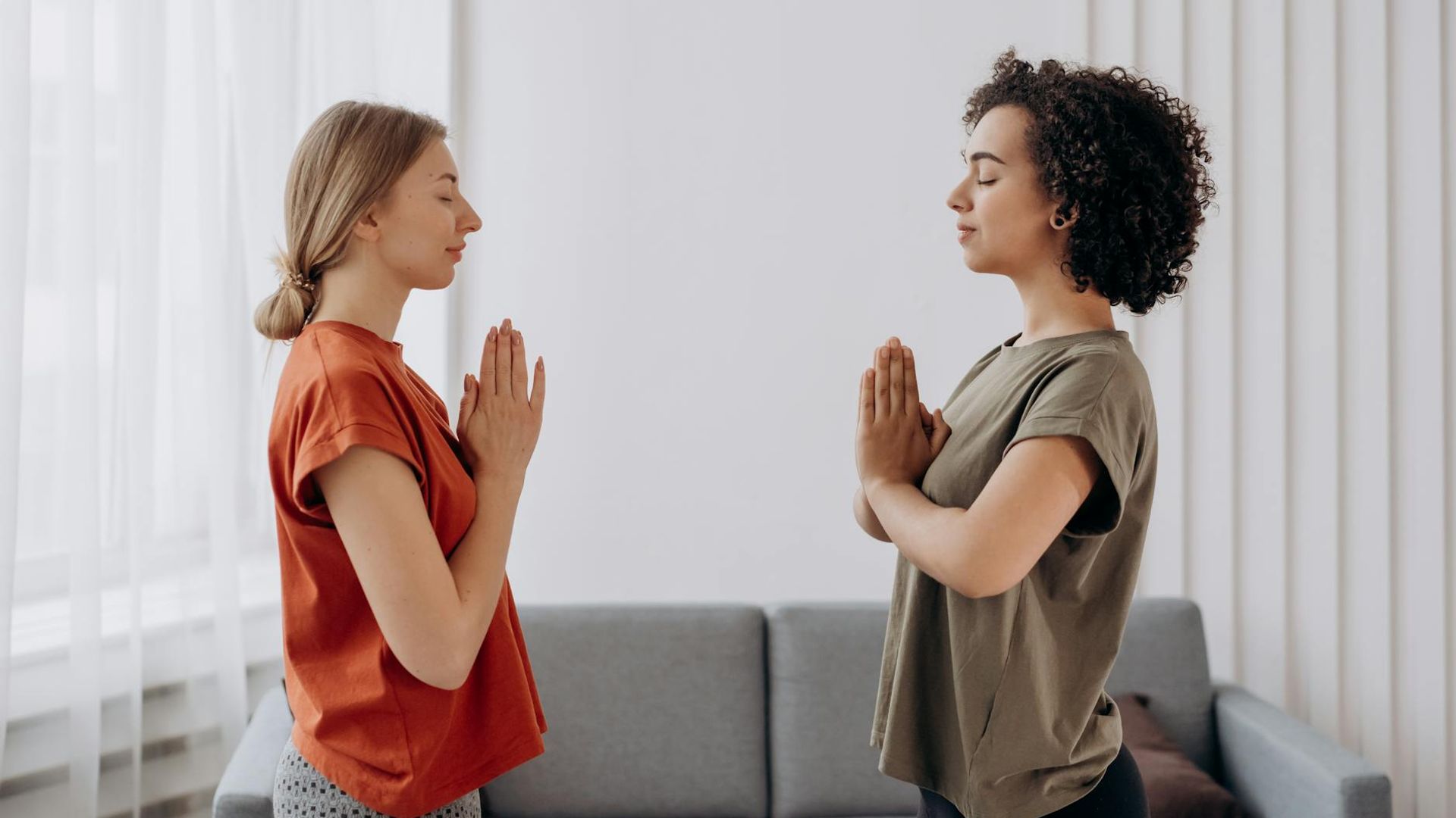 Calm and focused person practicing yoga in a dark room.
